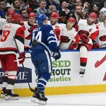 Mar 20, 2026; Toronto, Ontario, CAN; Carolina Hurricanes defenseman K'Andre Miller (19) celebrates with team mates at the bench after stealing the puck from Toronto Maple Leafs defenseman Morgan Rielly (44) in the second period at Scotiabank Arena.