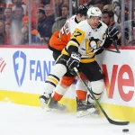 Apr 29, 2026; Philadelphia, Pennsylvania, USA; Pittsburgh Penguins center Sidney Crosby (87) reaches for the puck against Philadelphia Flyers defenseman Rasmus Ristolainen (55) in the second period in game six of the first round of the 2026 Stanley Cup Playoffs at Xfinity Mobile Arena.