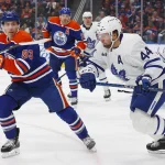 Mar 1, 2023; Edmonton, Alberta, CAN; Edmonton Oilers forward Ryan Nugent-Hopkins (93) and Toronto Maple Leafs defensemen Morgan Rielly (44) chase a loose puck during the first period at Rogers Place.
