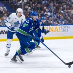 Feb 8, 2025; Vancouver, British Columbia, CAN; Vancouver Canucks forward Elias Pettersson (40) handles the puck against Toronto Maple Leafs forward Auston Matthews (34) in the third period at Rogers Arena.