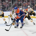 NHL bringing regular-season games to some German cities for first time in 2027-28 and two teams are named Dec 31, 2025; Edmonton, Alberta, CAN; Edmonton Oilers center Leon Draisaitl (29) plays the puck in front of Boston Bruins goalie Jeremy Swayman (1) during the third period at Rogers Place. Mandatory Credit: Walter Tychnowicz-Imagn Images