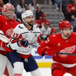 Jan 29, 2026; Detroit, Michigan, USA; Washington Capitals right wing Tom Wilson (43) and Detroit Red Wings center Dylan Larkin (71) fight for position in front of goaltender John Gibson (36) in the first period at Little Caesars Arena.