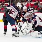 Blue Jackets dealt tough Elvis Merzlikins update before new season Dec 15, 2024; Raleigh, North Carolina, USA; Columbus Blue Jackets goaltender Elvis Merzlikins (90) right wing Kirill Marchenko (86) and defenseman Damon Severson (78) stop the shot by Carolina Hurricanes left wing Eric Robinson (50) during the third period at Lenovo Center. Mandatory Credit: James Guillory-Imagn Images