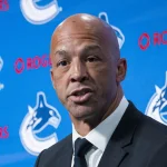 Jun 4, 2026; Vancouver, BC, CANADA; General manager Ryan Johnson listens to Manny Malhotra speak during press conference where the Vancouver Canucks introduce Malhotra as their new head coach during a press conference at Rogers Arena. :