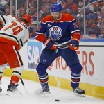 Apr 28, 2026; Edmonton, Alberta, CAN; Anaheim Ducks defensemen John Carlson (74) and Edmonton Oilers forward Leon Draisaitl (29) battle along the boards for a loose puck during the third period in game five of the first round of the 2026 Stanley Cup Playoffs at Rogers Place.