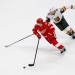 Mar 4, 2026; Detroit, Michigan, USA; Detroit Red Wings center Dylan Larkin (71) skates with the puck chased by Vegas Golden Knights left wing Ivan Barbashev (49) in the first period at Little Caesars Arena.