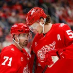 Jan 16, 2026; Detroit, Michigan, USADetroit Red Wings center Dylan Larkin (71) talks with defenseman Moritz Seider (53) during the first period against the San Jose Sharks at Little Caesars Arena.