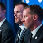 May 14, 2026; Vancouver, BC, Canada; Henrik Sedin and Ryan Johnson listen Daniel Sedin speak during a press conference where the Vancouver Canucks name new senior management staff. Henrik Sedin and his twin brother Daniel Sedin have been appointed as co-presidents of hockey operations and Ryan Johnson is now the new general manager of the club at Rogers Arena.