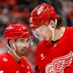 Jan 16, 2026; Detroit, Michigan, USADetroit Red Wings center Dylan Larkin (71) talks with defenseman Moritz Seider (53) during the first period against the San Jose Sharks at Little Caesars Arena. Mandatory Credit: Brian Bradshaw Sevald-Imagn Images