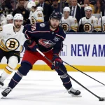 Apr 12, 2026; Columbus, Ohio, USA; Columbus Blue Jackets center Adam Fantilli (19) looks to pass as Boston Bruins center Mark Kastelic (47) trails the play during the first period at Nationwide Arena.