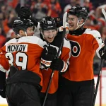 Apr 14, 2026; Philadelphia, Pennsylvania, USA; Philadelphia Flyers defenseman Oliver Bonk (59) celebrates his goal with right wing Matvei Michkov (39) and defenseman Hunter McDonald (75) against the MontrŽal Canadiens during the first period at Xfinity Mobile Arena. :