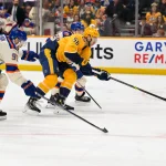 Jan 13, 2026; Nashville, Tennessee, USA; Nashville Predators left wing Michael Bunting (58) skates between Edmonton Oilers defenseman Jake Walman (96) and defenseman Spencer Stastney (24) during the first period at Bridgestone Arena.