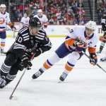 Apr 13, 2025; Newark, New Jersey, USA; New Jersey Devils right wing Daniel Sprong (10) skates with the puck as New York Islanders left wing Anders Lee (27) defends during the third period at Prudential Center. Mandatory Credit: Ed Mulholland-Imagn Images