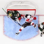 Jan 12, 2026; Saint Paul, Minnesota, USA; Minnesota Wild defensemen Quinn Hughes (43) sends New Jersey Devils forward Arseny Gritsyuk (81) flying through the crease of goalie Jesper Wallstedt (30) during the third period at Grand Casino Arena. Mandatory Credit: Nick Wosika-Imagn Images