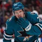 Apr 8, 2026; San Jose, California, USA; San Jose Sharks center Macklin Celebrini (71) adjusts his mouthpiece during a break in the action against the Edmonton Oilers in the second period at SAP Center at San Jose. Mandatory Credit: David Gonzales-Imagn Images