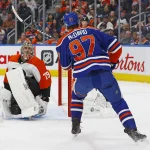 Jan 2, 2024; Edmonton, Alberta, CAN; Edmonton Oilers forward Connor McDavid (97) scores a goal during the first period on Philadelphia Flyers goaltender Carter Hart (79) at Rogers Place.