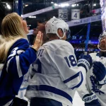 Feb 25, 2026; Tampa, Florida, USA; Toronto Maple Leafs forward Steven Lorentz (18) and defenseman Simon Benoit (2) interacting with a fan before the game against the Tampa Bay Lightning at Benchmark International Arena.