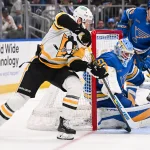 Apr 14, 2026; St. Louis, Missouri, USA; St. Louis Blues goaltender Jordan Binnington (50) makes a save against Pittsburgh Penguins right wing Kevin Hayes (13) during the first period at Enterprise Center.