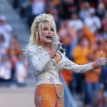 Country music artist Dolly Parton sings to the crowd during a break in a game between the Tennessee Volunteers and the Georgia Bulldogs at Neyland Stadium, Nov. 18, 2023.
