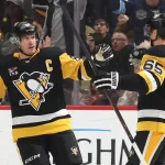Dec 16, 2025; Pittsburgh, Pennsylvania, USA; Pittsburgh Penguins center Sidney Crosby (87) congratulates defenseman Erik Karlsson (65) on his goal against the Edmonton Oilers during the second period at PPG Paints Arena.