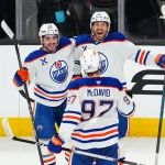 Edmonton Oilers dealt four injury blows ahead of training camp Mar 26, 2026; Las Vegas, Nevada, USA; Edmonton Oilers defenseman Evan Bouchard (2) celebrates with center Matt Savoie (22) and center Connor McDavid (97) after scoring a goal during an overtime period to give the Oilers a 4-3 victory over the Vegas Golden Knights at T-Mobile Arena. Mandatory Credit: Stephen R. Sylvanie-Imagn Images