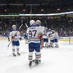 May 10, 2024; Vancouver, British Columbia, CAN; Edmonton Oilers forward Mattias Janmark (13) and forward Leon Draisaitl (29) and forward Connor McDavid (97) celebrate their victory against the Vancouver Canucks during the first overtime in game two of the second round of the 2024 Stanley Cup Playoffs at Rogers Arena.
