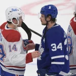 May 31, 2021; Toronto, Ontario, CAN; Toronto Maple Leafs forward Auston Matthews (34) congratulates Montreal Canadiens forward Nick Suzuki (14) after the Canadiens beat the Leafs 3-1 in game seven of the first round of the 2021 Stanley Cup Playoffs at Scotiabank Arena.