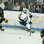 Oct 10, 2025; University Park, PA, USA; Penn State Nittany Lions forward JJ Wiebusch (86) looks to get by Clarkson Golden Knights players Adrian Misaljevic (86) and Matthew Mayich (21) in the second period of a game at Pegula Ice Arena.