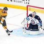 Apr 13, 2026; Las Vegas, Nevada, USA; Winnipeg Jets goaltender Connor Hellebuyck (37) makes a save against a deflection by Vegas Golden Knights right wing Reilly Smith (19) during the third period at T-Mobile Arena.