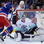 Jan 16, 2024; New York, New York, USA; Seattle Kraken goaltender Chris Driedger (60) makes a save against New York Rangers center Barclay Goodrow (21) during the first period at Madison Square Garden. Mandatory Credit: Brad Penner-USA TODAY Sports