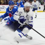 Jan 12, 2026; Denver, Colorado, USA; Toronto Maple Leafs center Auston Matthews (34) and Colorado Avalanche defenseman Cale Makar (8) battle for the puck in the third period at Ball Arena.