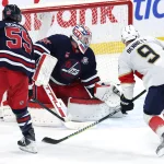 Jan 22, 2026; Winnipeg, Manitoba, CAN; Florida Panthers center Sam Bennett (9) shoots wide of Winnipeg Jets goaltender Connor Hellebuyck (37) in overtime at Canada Life Centre.