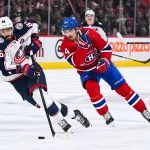 16 novembre 2024; Montréal, Québec, Canada; Kirill Marchenko (86), ailier droit des Blue Jackets de Columbus, joue la rondelle contre Nick Suzuki (14), centre des Canadiens de Montréal, durant la première période au Centre Bell.