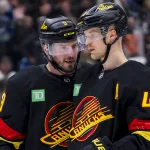 Dec 23, 2024; Vancouver, British Columbia, CAN; Vancouver Canucks forward J.T. Miller (9) and forward Elias Pettersson (40) talk during a stop in play against the San Jose Sharks in the first period at Rogers Arena. Mandatory Credit: Bob Frid-Imagn Images