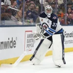 Apr 4, 2026; Columbus, Ohio, USA; Winnipeg Jets goalie Connor Hellebuyck (37) plays the puck on a Columbus Blue Jackets dump in during the second period at Nationwide Arena. Mandatory Credit: Russell LaBounty-Imagn Images