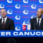 Jun 4, 2026; Vancouver, BC, CANADA; General manager Ryan Johnson listens to Manny Malhotra speak during press conference where the Vancouver Canucks introduce Malhotra as their new head coach during a press conference at Rogers Arena.