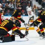 Apr 7, 2026; Vancouver, British Columbia, CAN; Vancouver Canucks defenseman Filip Hronek (17) and forward Elias Pettersson (40) watch as goalie Nikita Tolopilo (60) makes a save on Vegas Golden Knights forward Pavel Dorofeyev (16) in the first period at Rogers Arena. Mandatory Credit:
