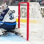 Apr 13, 2026; Las Vegas, Nevada, USA; A shot by Vegas Golden Knights right wing Mark Stone (61) (not pictured) slips across the goal line behind Winnipeg Jets goaltender Connor Hellebuyck (37) during the second period at T-Mobile Arena.