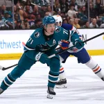 Apr 8, 2026; San Jose, California, USA; San Jose Sharks center Macklin Celebrini (71) skates toward the puck while defended by Edmonton Oilers center Matthew Savoie (22) in the second period at SAP Center at San Jose. Mandatory Credit: David Gonzales-Imagn Images