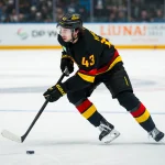 Dec 11, 2025; Vancouver, British Columbia, CAN; Vancouver Canucks defenseman Quinn Hughes (43) handles the puck against the Buffalo Sabres in the first period at Rogers Arena.