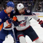 Mar 22, 2026; Elmont, New York, USA; New York Islanders defenseman Matthew Schaefer (48) fights for position against Columbus Blue Jackets right wing Kirill Marchenko (86) during the first period at UBS Arena.
