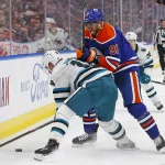 Mar 20, 2023; Edmonton, Alberta, CAN; Edmonton Oilers forward Evander Kane (91) and San Jose Sharks forward Evgeny Svechnikov (10) battle for a loose puck during the second period at Rogers Place. Mandatory Credit: Perry Nelson-USA TODAY Sports