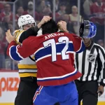 Nov 15, 2025; Montreal, Quebec, CAN; Boston Bruins forward Tanner Jeannot (84) fights Montreal Canadiens defenseman Arber Xhekaj (72) during the first period at the Bell Centre.