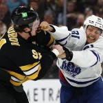 Mar 24, 2026; Boston, Massachusetts, USA; Toronto Maple Leafs center Dakota Joshua (81) fights with Boston Bruins defenseman Nikita Zadorov (91) during the third period at TD Garden.