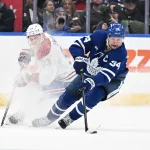 Dec 6, 2025; Toronto, Ontario, CAN; Toronto Maple Leafs forward Auston Matthews (34) stickhandles past Montreal Canadiens forward Ivan Demidov (93) in overtime at Scotiabank Arena.