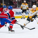 5 décembre 2024; Montréal, Québec, Canada; l'ailier droit des Predators de Nashville, Luke Evangelista (77), joue la rondelle contre le défenseur des Canadiens de Montréal, Jayden Struble (47), durant la troisième période au Centre Bell.