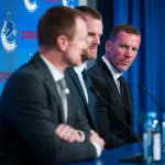May 14, 2026; Vancouver, BC, Canada; Ryan Johnson and Daniel Sedin listen to Henrik Sedin speak during a press conference where the Vancouver Canucks name new senior management staff. Henrik Sedin and his twin brother Daniel Sedin have been appointed as co-presidents of hockey operations and Ryan Johnson is now the new general manager of the club at Rogers Arena