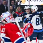 3 décembre 2025; Montréal, Québec, Canada; L'ailier gauche des Jets de Winnipeg, Kyle Connor (81), célèbre avec le centre Mark Scheifele (55) après un but marqué contre le gardien des Canadiens de Montréal, Jakub Dobes (75), en deuxième période au Centre Bell.
