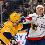Jan 11, 2026; Nashville, Tennessee, USA; Nashville Predators left wing Michael Bunting (58) and Washington Capitals defenseman John Carlson (74) during the third period at Bridgestone Arena.