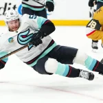Apr 15, 2026; Las Vegas, Nevada, USA; Seattle Kraken center Shane Wright (51) is tripped up by Vegas Golden Knights center Tomas Hertl (48) during the second period at T-Mobile Arena.